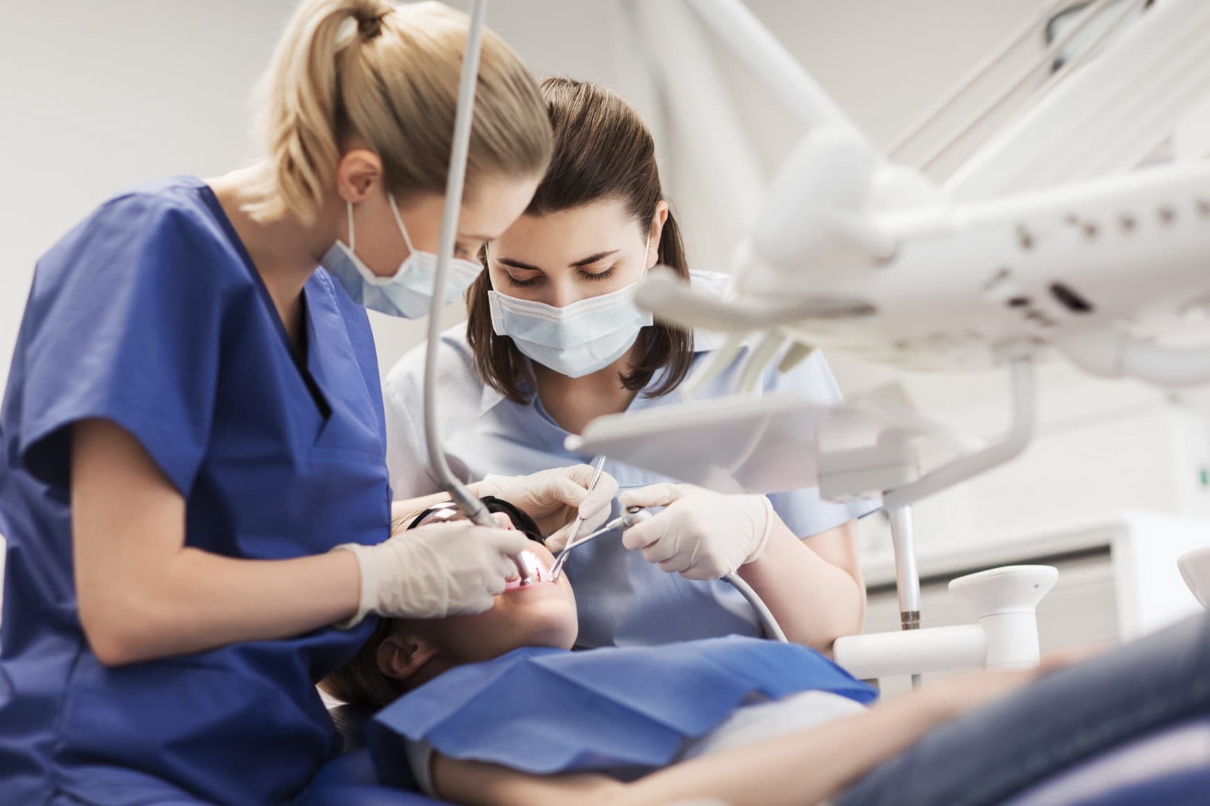 Two clinicians working the same case together at the chair